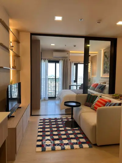Modern studio apartment with cozy living area and stylish bedroom, featuring a vibrant decor and city view.