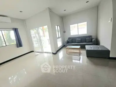 Spacious living room with modern furniture and large windows for natural light.