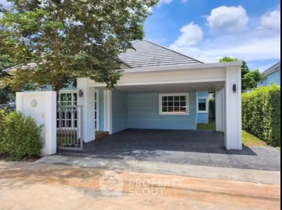 Charming suburban home with spacious driveway and lush greenery, perfect for family living.