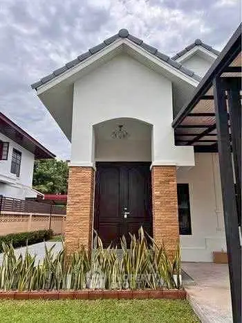 Charming modern house exterior with lush garden and stylish entrance