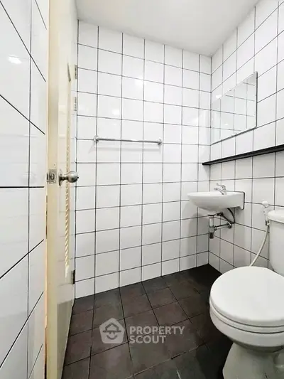Modern minimalist bathroom with white tiles and sleek fixtures