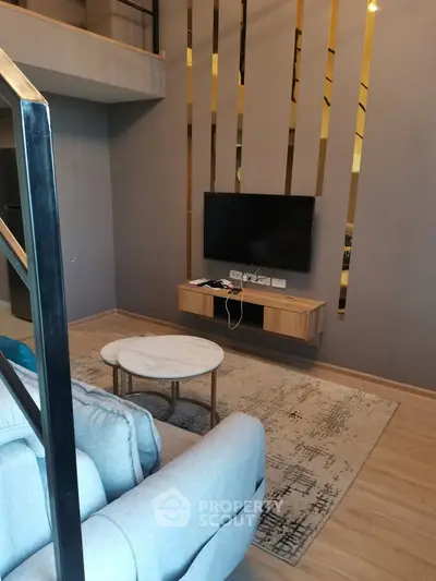 Modern living room with stylish decor and wall-mounted TV in a contemporary apartment.