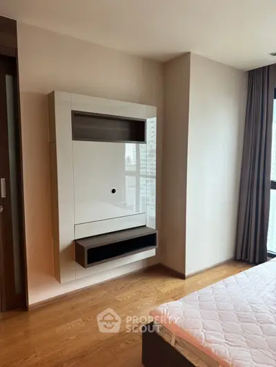 Modern bedroom with sleek wall-mounted storage and large window view