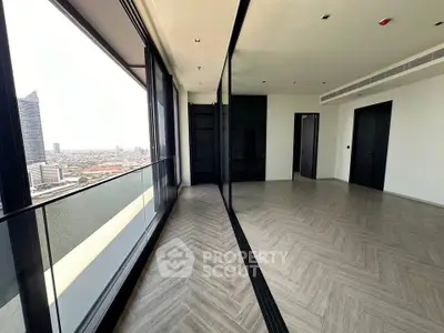 Spacious modern apartment with stunning city and river views, featuring floor-to-ceiling windows and elegant flooring.