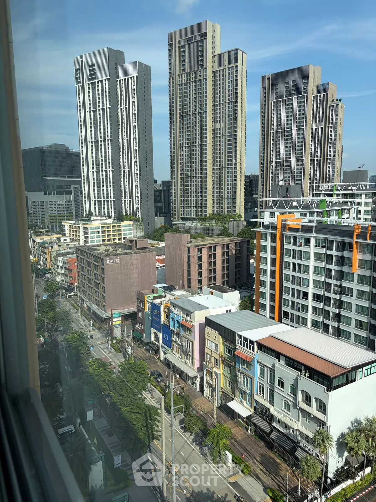 Stunning cityscape view from high-rise building window showcasing modern architecture and vibrant urban life.