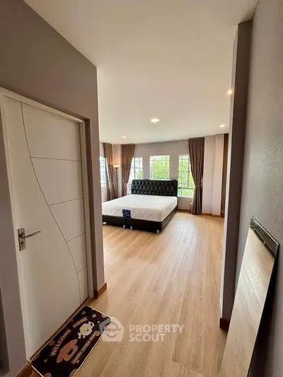 Spacious modern bedroom with large windows and elegant decor