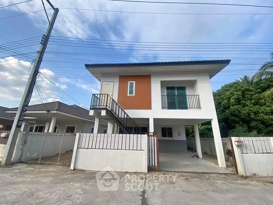Modern two-story house with elevated design and spacious driveway