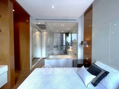 Luxurious bedroom with modern design and city view, featuring a glass-enclosed bathtub for ultimate relaxation.