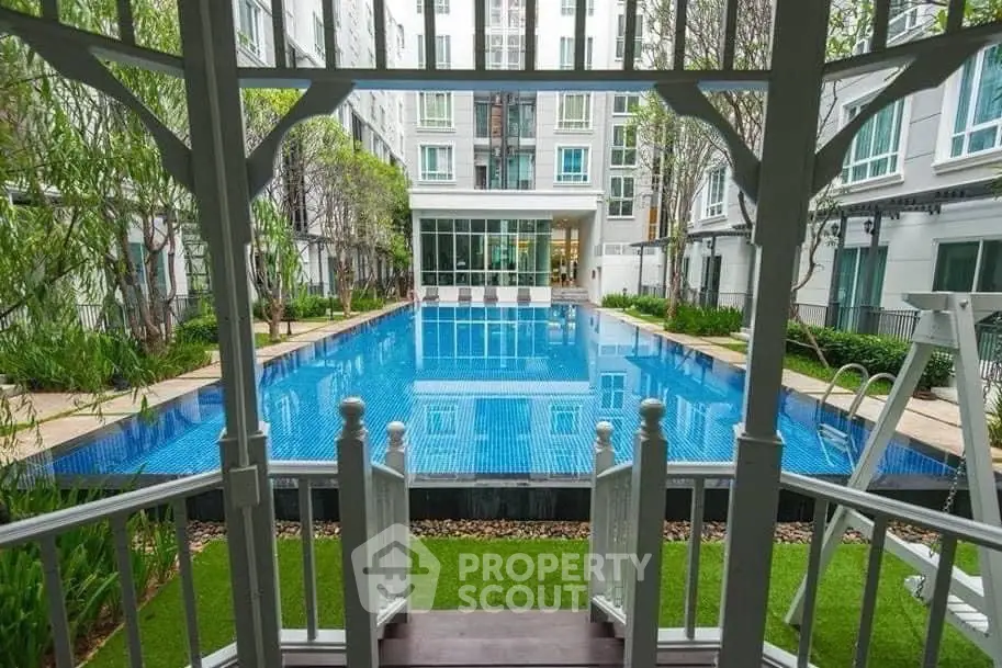 Luxurious apartment complex with a stunning outdoor pool and lush greenery, perfect for relaxation and leisure.