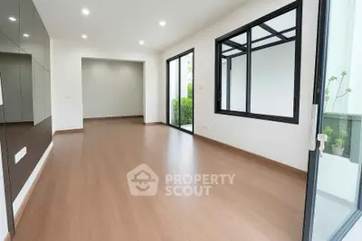 Spacious modern living room with large windows and wooden flooring