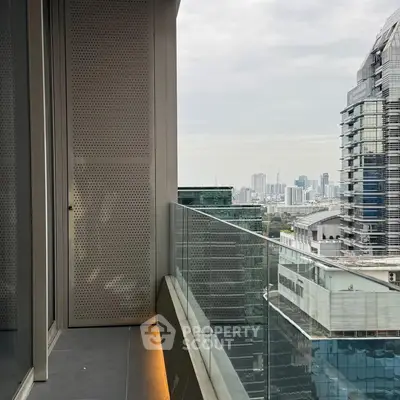 Modern balcony with glass railing offering stunning cityscape views.
