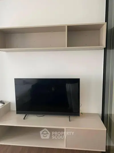 Modern living room with sleek TV stand and wall-mounted shelves