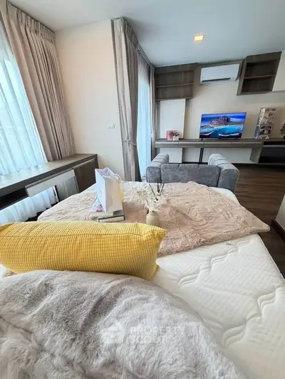 Spacious modern living room with cozy decor and large windows offering natural light.