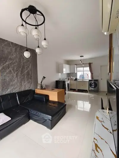 Modern living room with sleek black sofa and stylish lighting