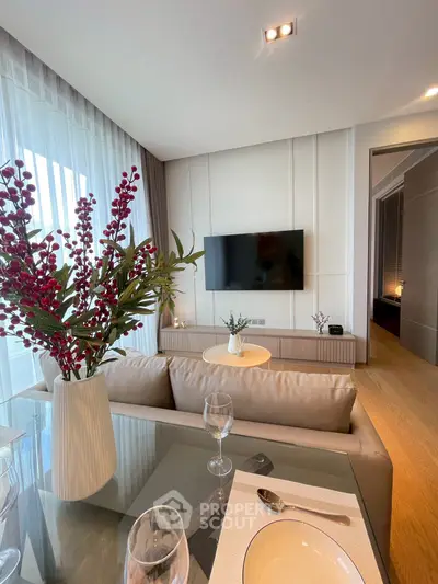 Modern living room with elegant decor and wall-mounted TV, perfect for relaxation and entertainment.