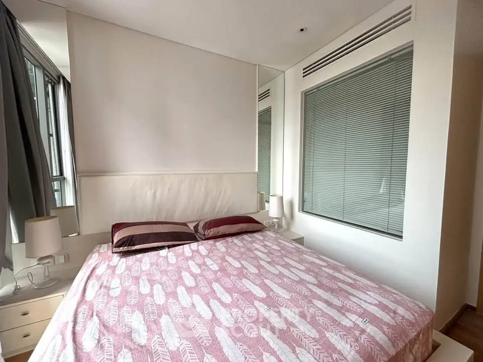 Modern bedroom with large bed and stylish decor in a bright apartment.