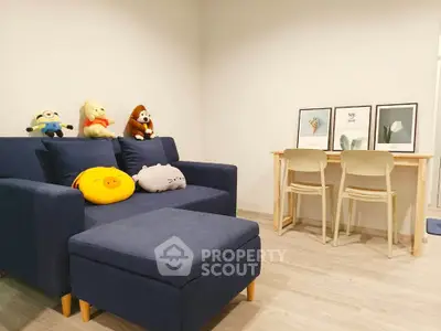 Cozy living room with plush sofa and stylish dining area, perfect for relaxation and entertaining.