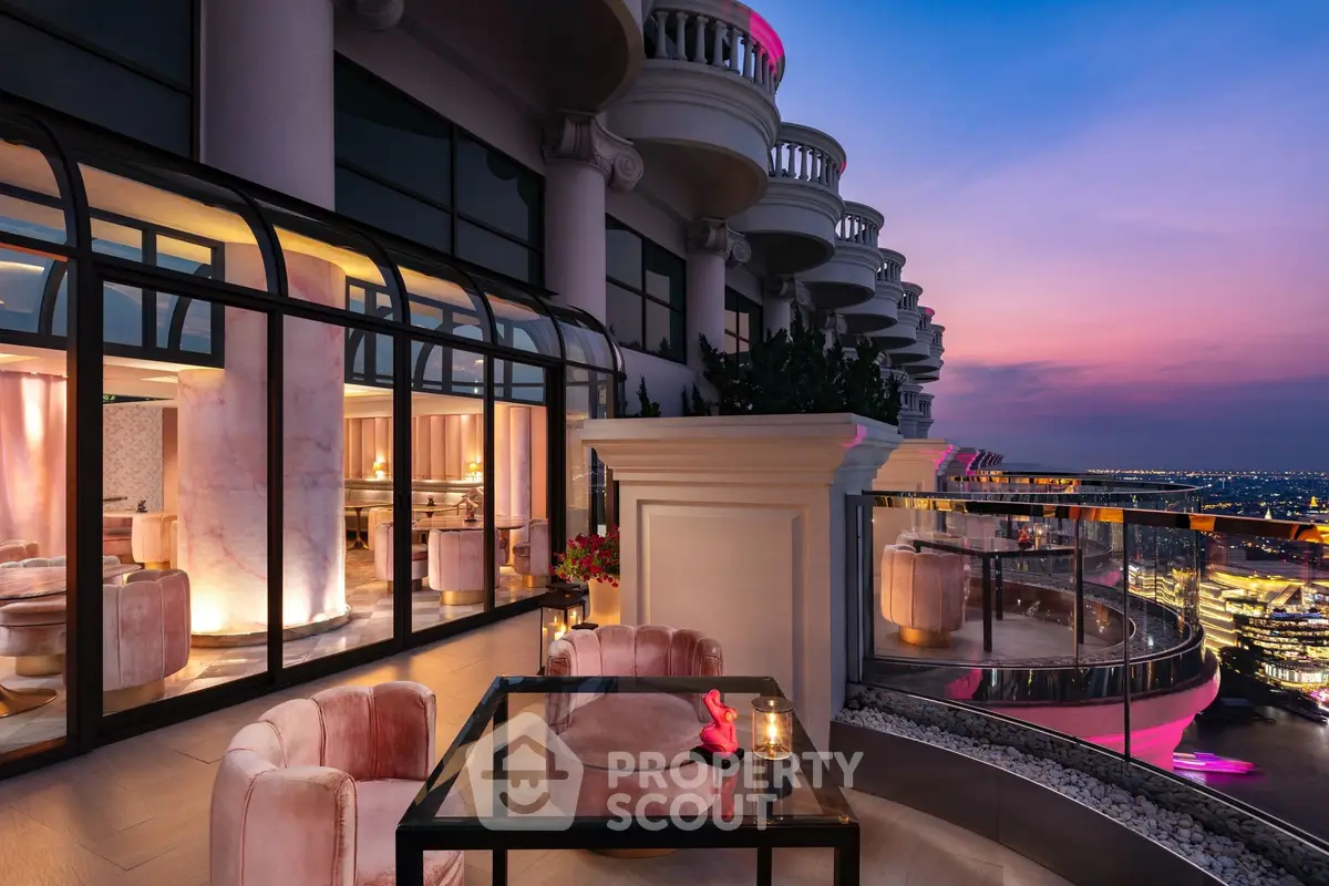Luxurious balcony with stunning city view at sunset, featuring elegant seating and modern design.