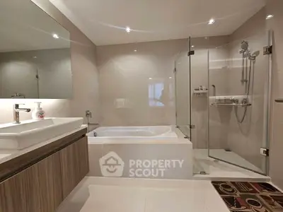 Luxurious modern bathroom with bathtub and glass shower enclosure