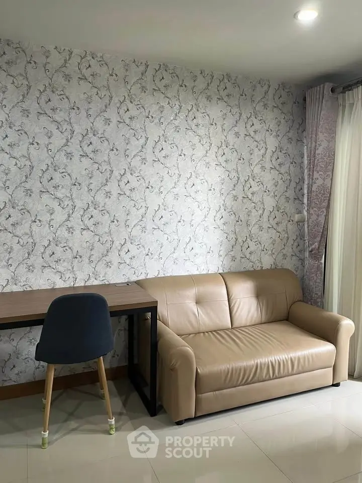 Modern living room with stylish wallpaper, cozy sofa, and elegant curtains, perfect for relaxation and work.