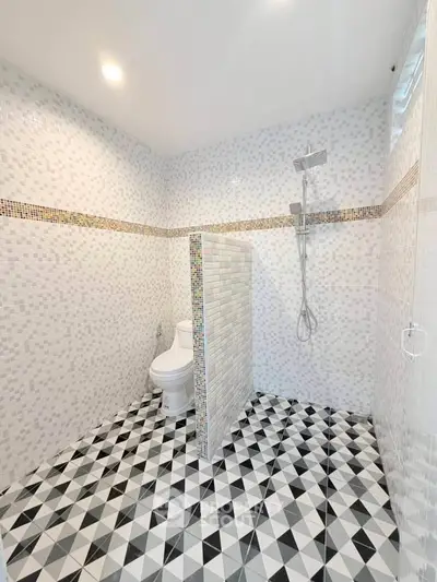Modern bathroom with geometric tile flooring and open shower design