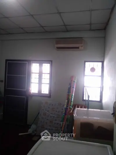 Cozy room with air conditioning and natural light, perfect for storage or small office setup.