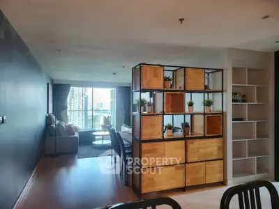 Modern living room with city view, stylish shelving, and cozy seating area.