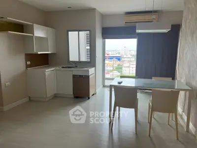 Modern open-layout kitchen with dining area and city view