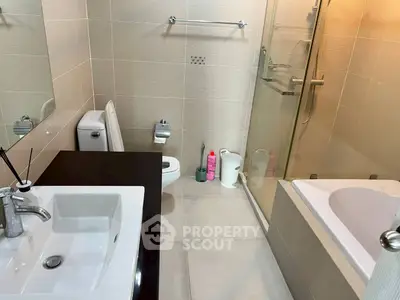 Modern bathroom with sleek fixtures and spacious shower area