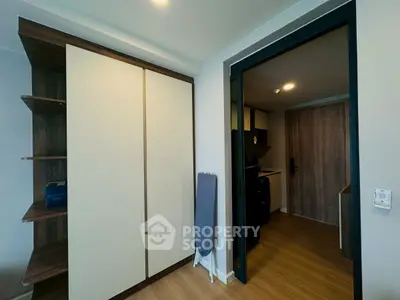Modern apartment interior with sleek storage and open kitchen layout