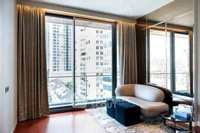 Luxurious living room with floor-to-ceiling windows offering stunning city views in a modern apartment.