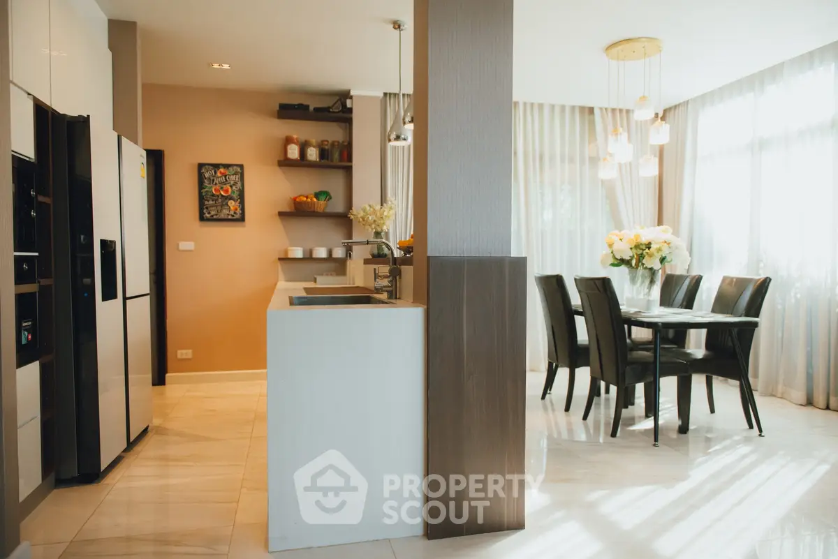 Modern kitchen and dining area with elegant decor and natural light