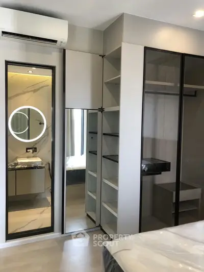 Modern bedroom with sleek closet and stylish vanity mirror