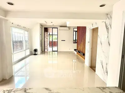 Spacious modern living room with marble accents and large windows