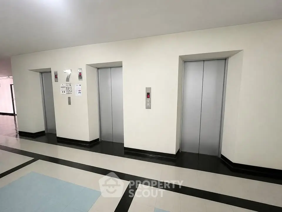 Modern building elevator lobby with sleek design and polished floors.