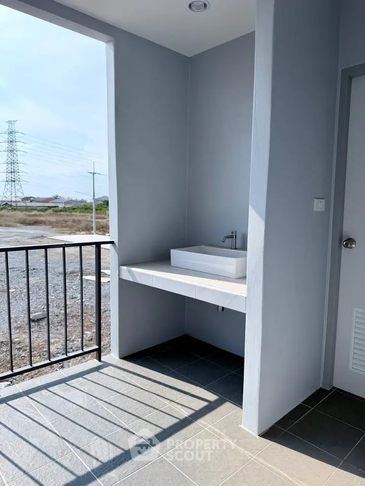 Modern balcony with sleek sink and open view, perfect for relaxation and outdoor enjoyment.