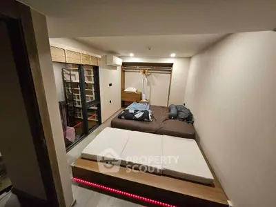 Modern bedroom with platform bed and ambient lighting in cozy apartment