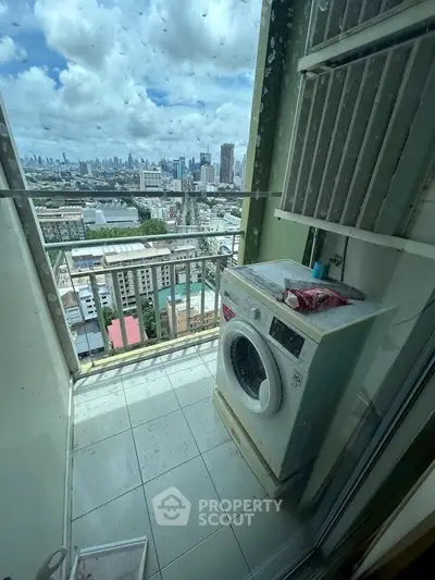 High-rise balcony with washing machine and stunning city skyline view.