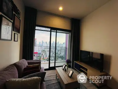 Spacious living room with plush seating and large windows offering a panoramic city view, perfect for relaxation and entertainment.