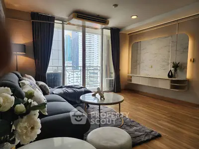 Modern living room with elegant decor and city view balcony