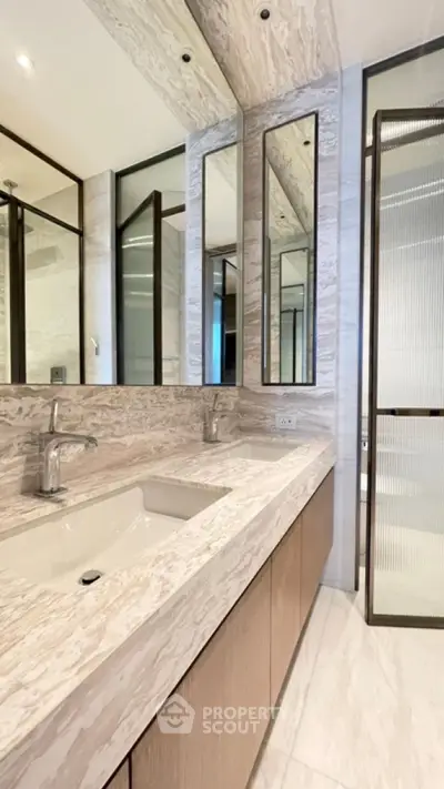 Luxurious modern bathroom with dual sinks and elegant marble countertops.