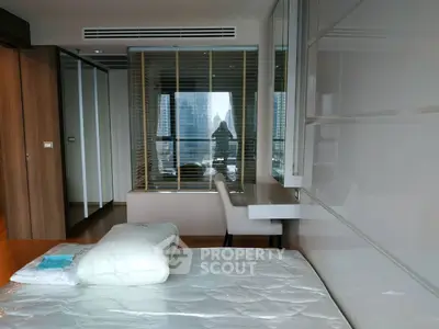 Modern bedroom with city view and sleek furniture in high-rise apartment