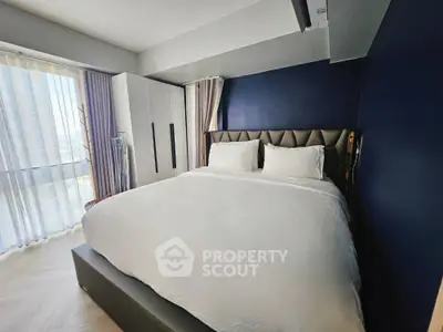 Luxurious bedroom with plush bed and modern decor in high-rise apartment