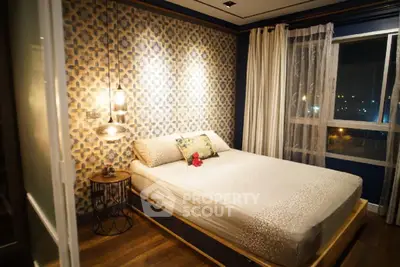 Stylish bedroom with modern decor and large window offering city views.