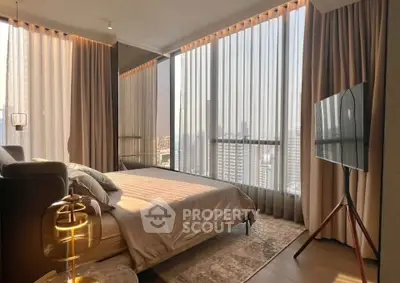 Luxurious bedroom with floor-to-ceiling windows and city view