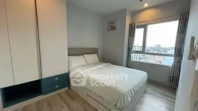 Modern bedroom with city view, featuring sleek design and ample natural light.