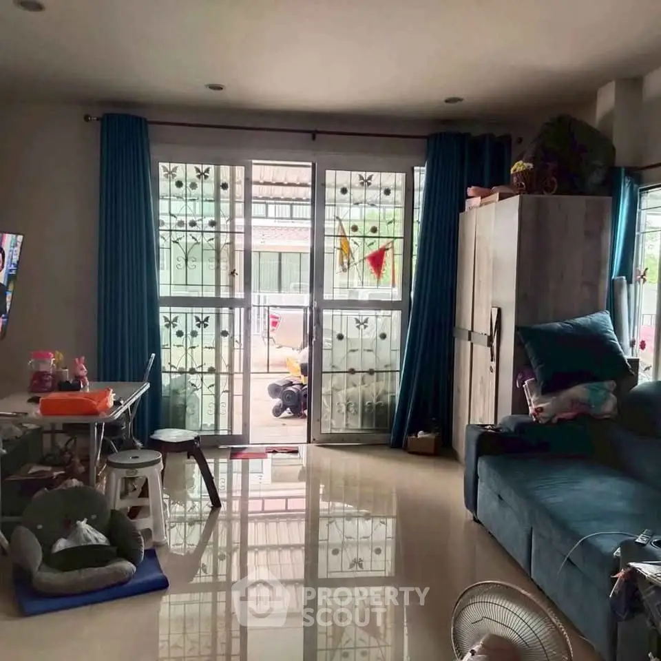 Cozy living room with large windows and modern furniture