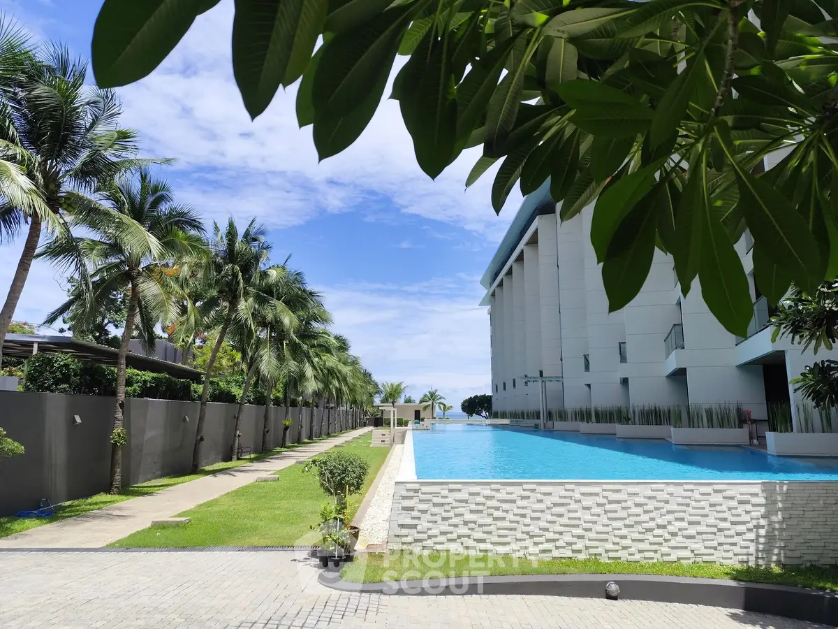 Luxurious apartment building with stunning pool and lush palm trees