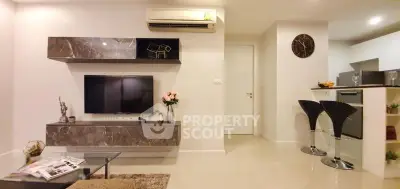 Modern living room with stylish decor and open kitchen layout