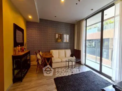 Stylish living room with modern decor and large glass doors leading to balcony.